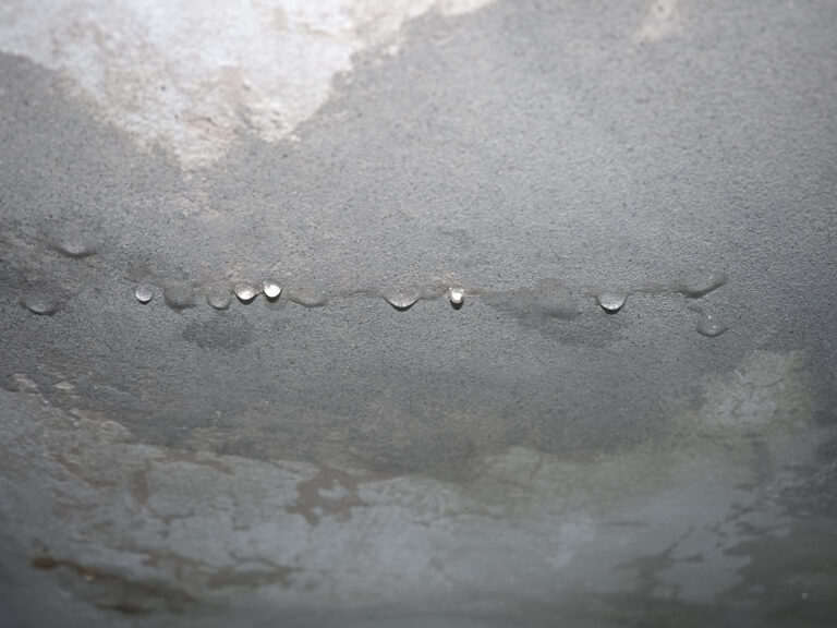dampness moisture on ceiling with drops of water infiltration
